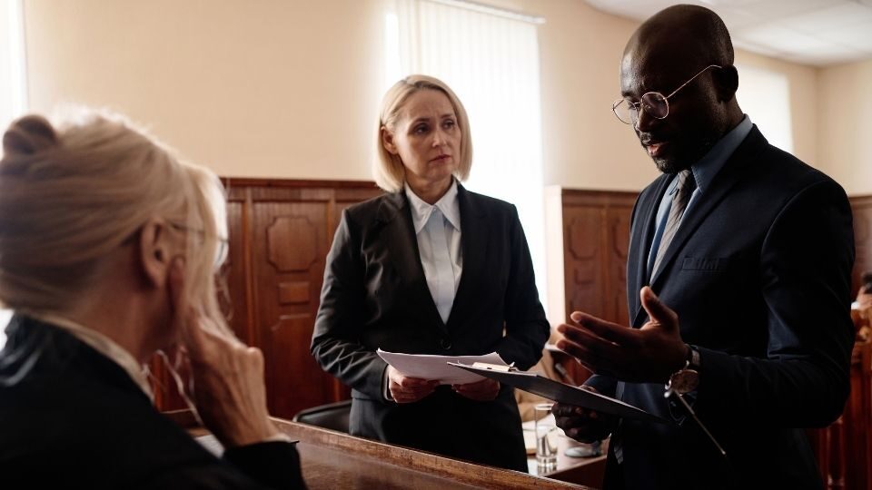 (In the image it can be seen solicitors discussing defamation case)