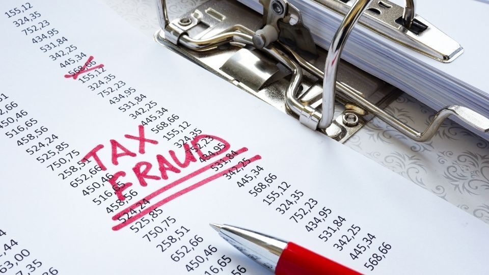 (In the image the concept for Tax fraud sentence uk can be seen showcasing corruption)