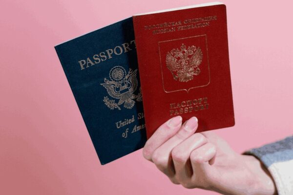 person showing 2 passport of a dual citizenship