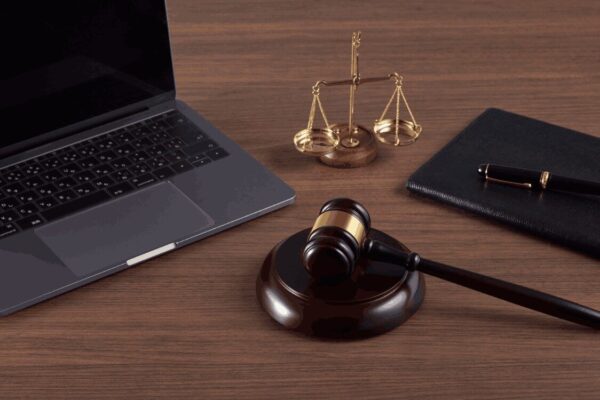 images showing table in solicitors office with laptop on it