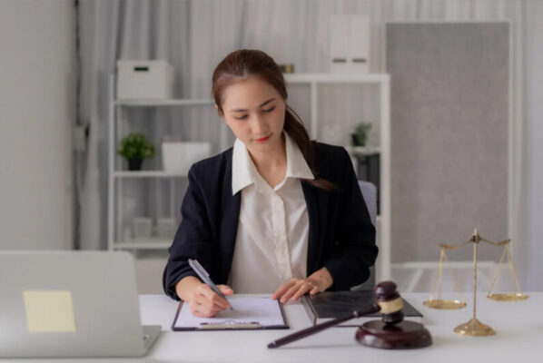 (Legal professional reviewing property documents to set up a land registry fraud alert.)