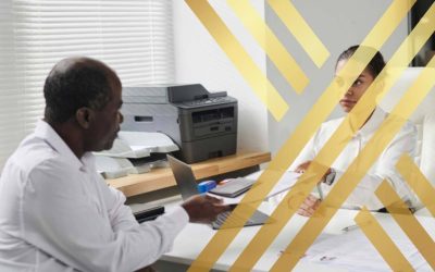An immigration applicant handing documents across a desk to a reviewing officer for an eligibility assessment for Global Talent ILR.