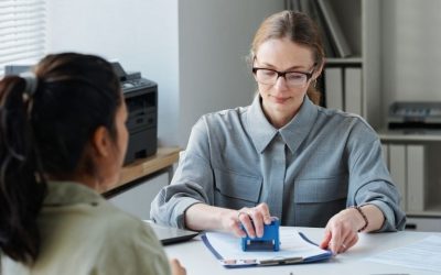 (In the image an immigration solicitor can be seen approving a temporary work visa UK) UK 2-Year Temporary Work Visa Complete Application Process