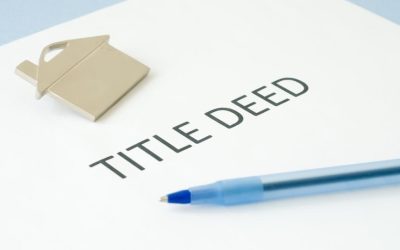 (In the image it can be seen a paper is there having title deed written along with a property symbol) What Do Property Title Deeds UK Look Like