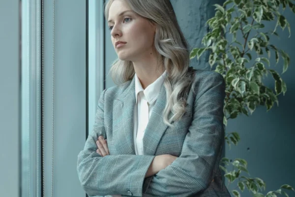 A photo of a caring domestic violence family law solicitor that looks out of the window thinking about a clients case in Birmingham.